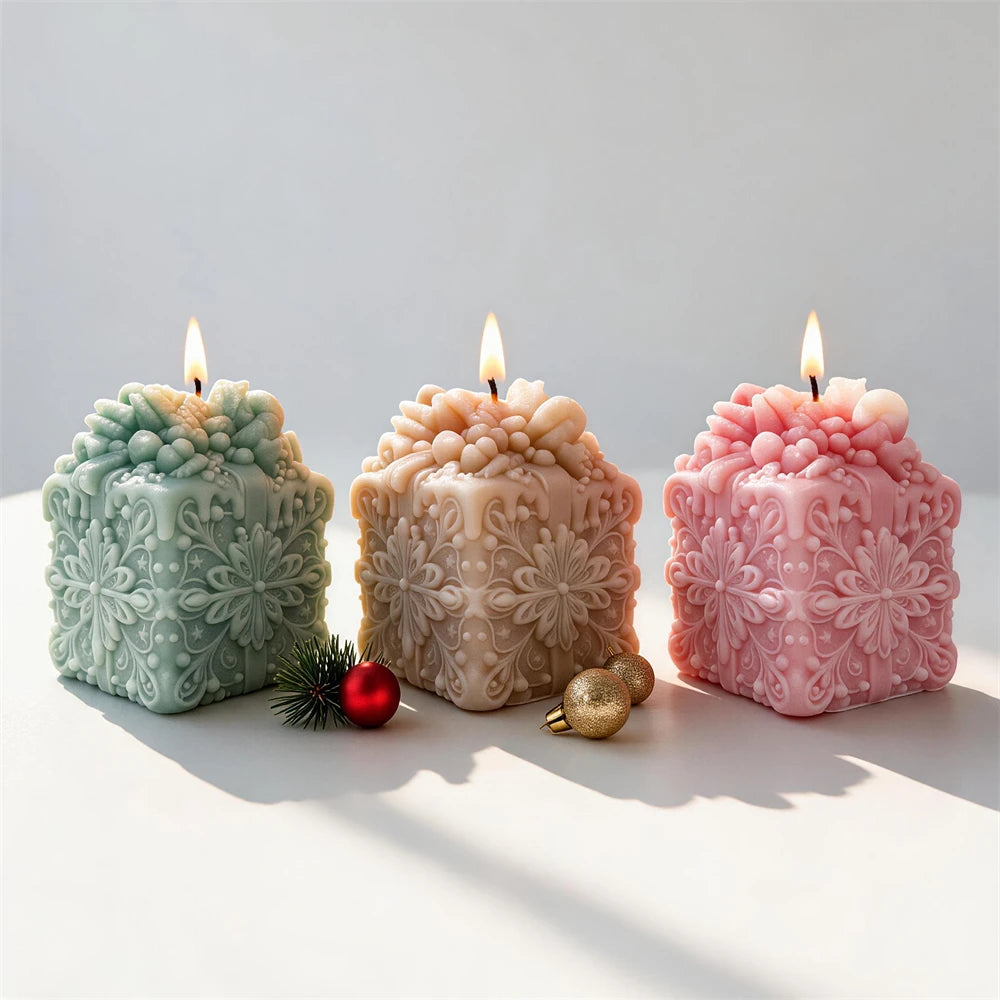 green pink and cream snowflake gift box candles for festive décor