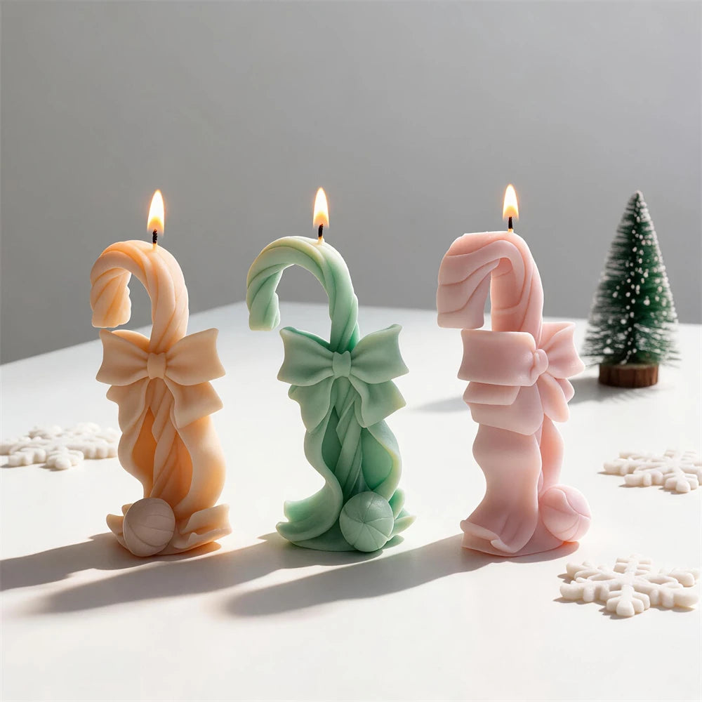 Pink cream sage and gold bow-tied candy cane candles for Christmas décor