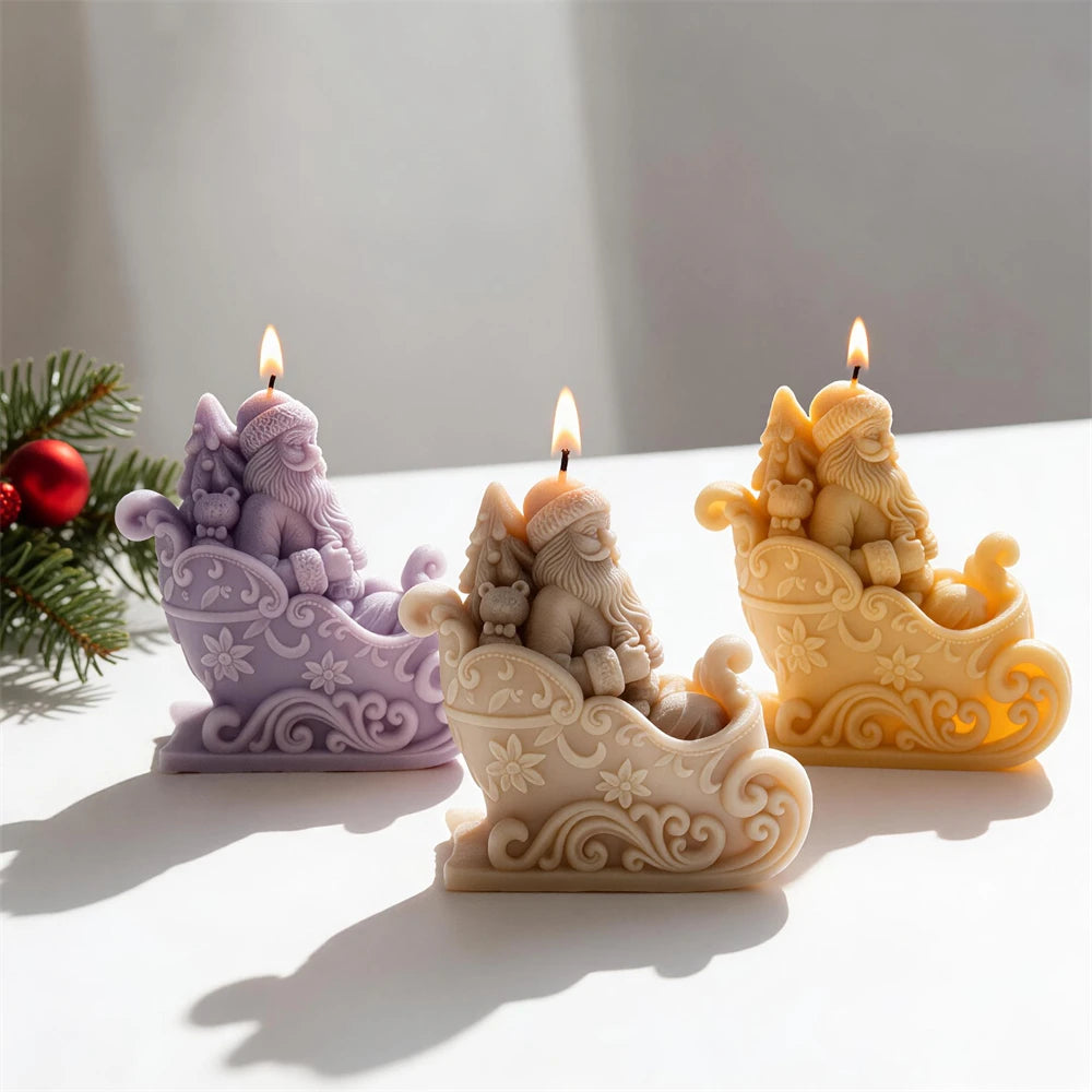 Father Christmas candle seated inside an ornate floral scroll sleigh