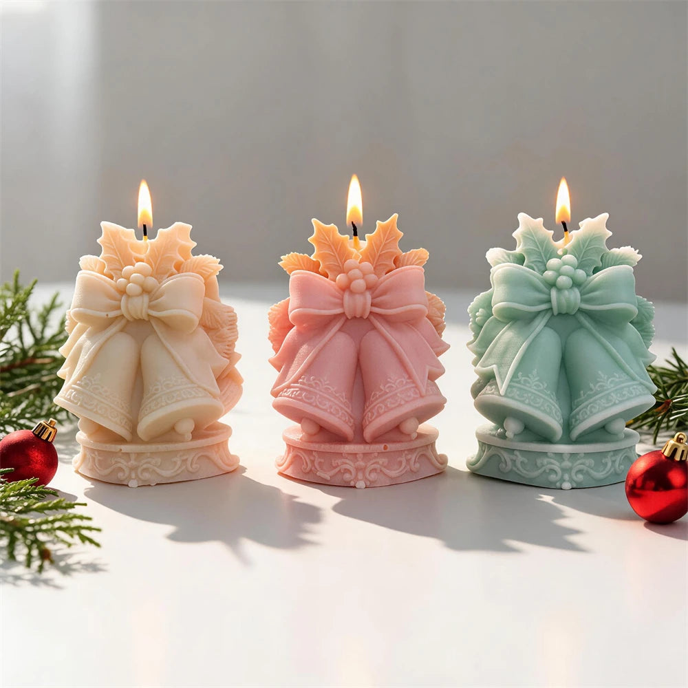 Christmas bells candles with large ribbon bows and festive holly details