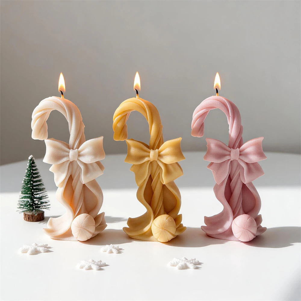 Christmas candy cane candle with oversized bow and curled ribbon details