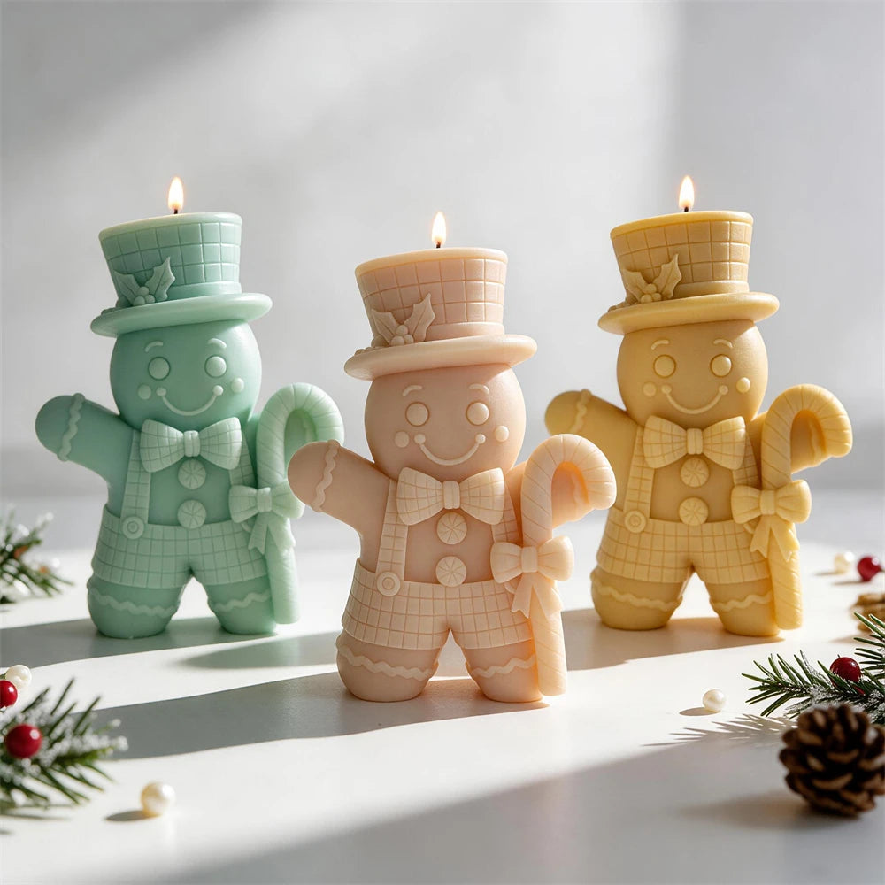 Top hat Gingerbread Man candle holding a large candy cane