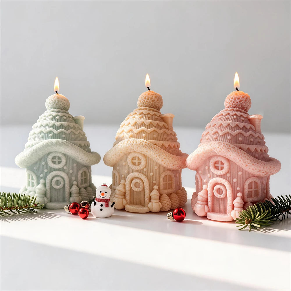 Knitted snow cottage candles with pom-pom roofs and tiny evergreen trees