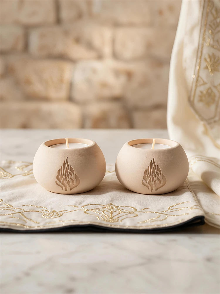 Round Judaica tea light holder with stylized flame symbol