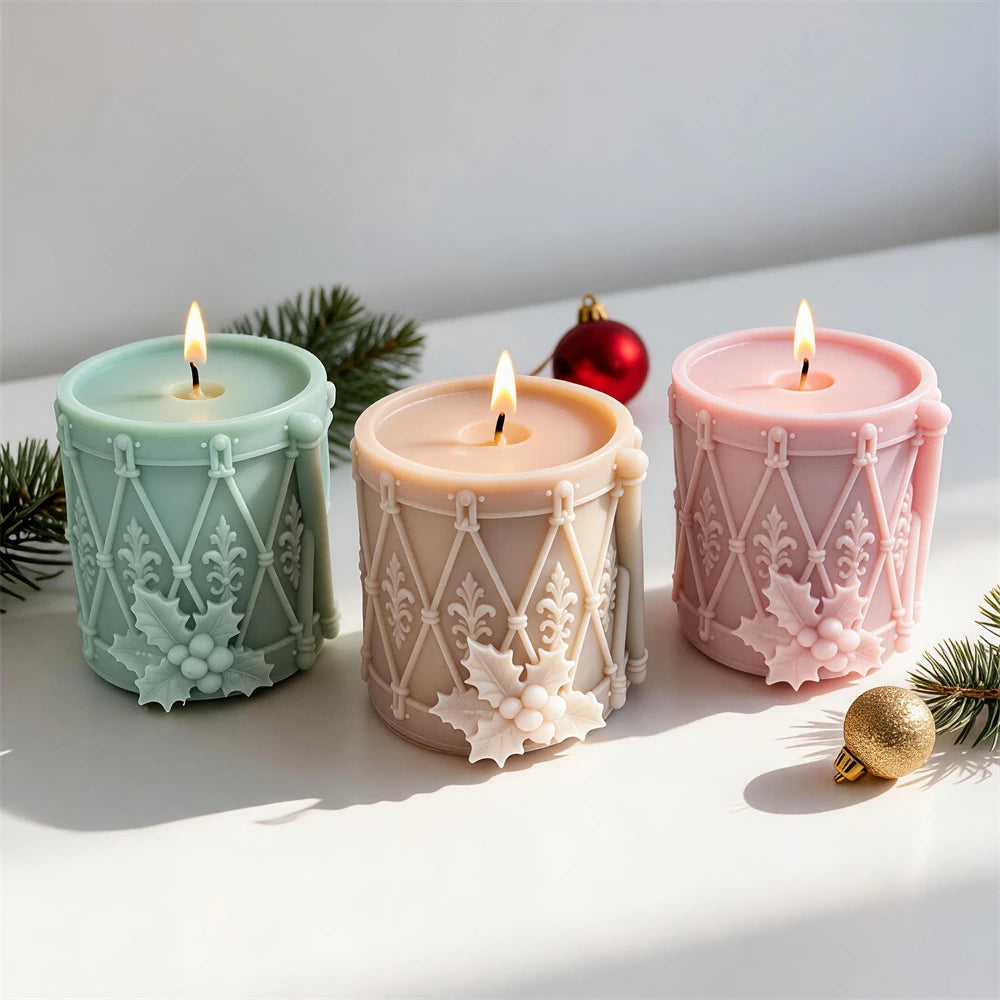 Festive toy drum candle with holly berry cluster and ornamental patterns