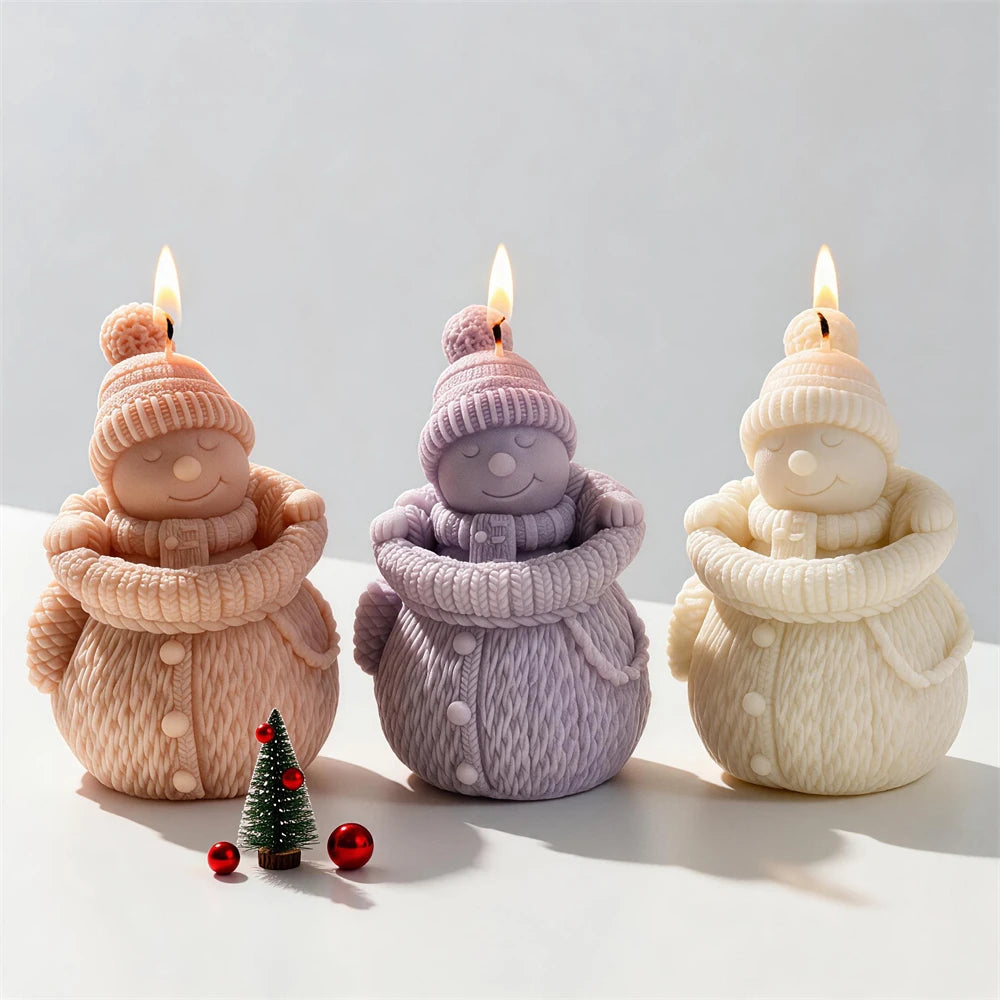 Knitted snowman candles with pom-pom hats and chunky winter scarves