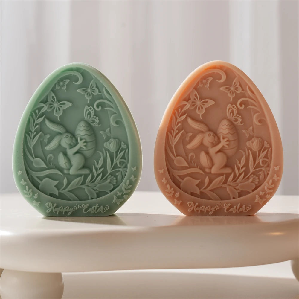 Two decorative Easter eggs with intricate designs on a white surface.