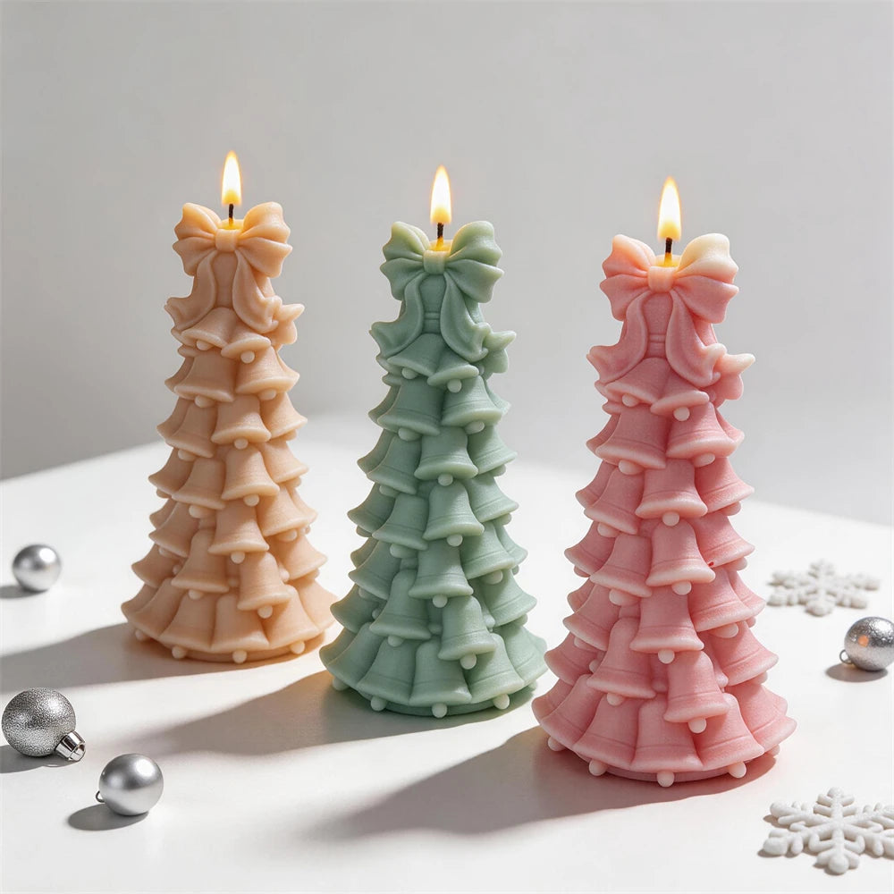 Stacked bell Christmas tree candles with large ribbon bow toppers
