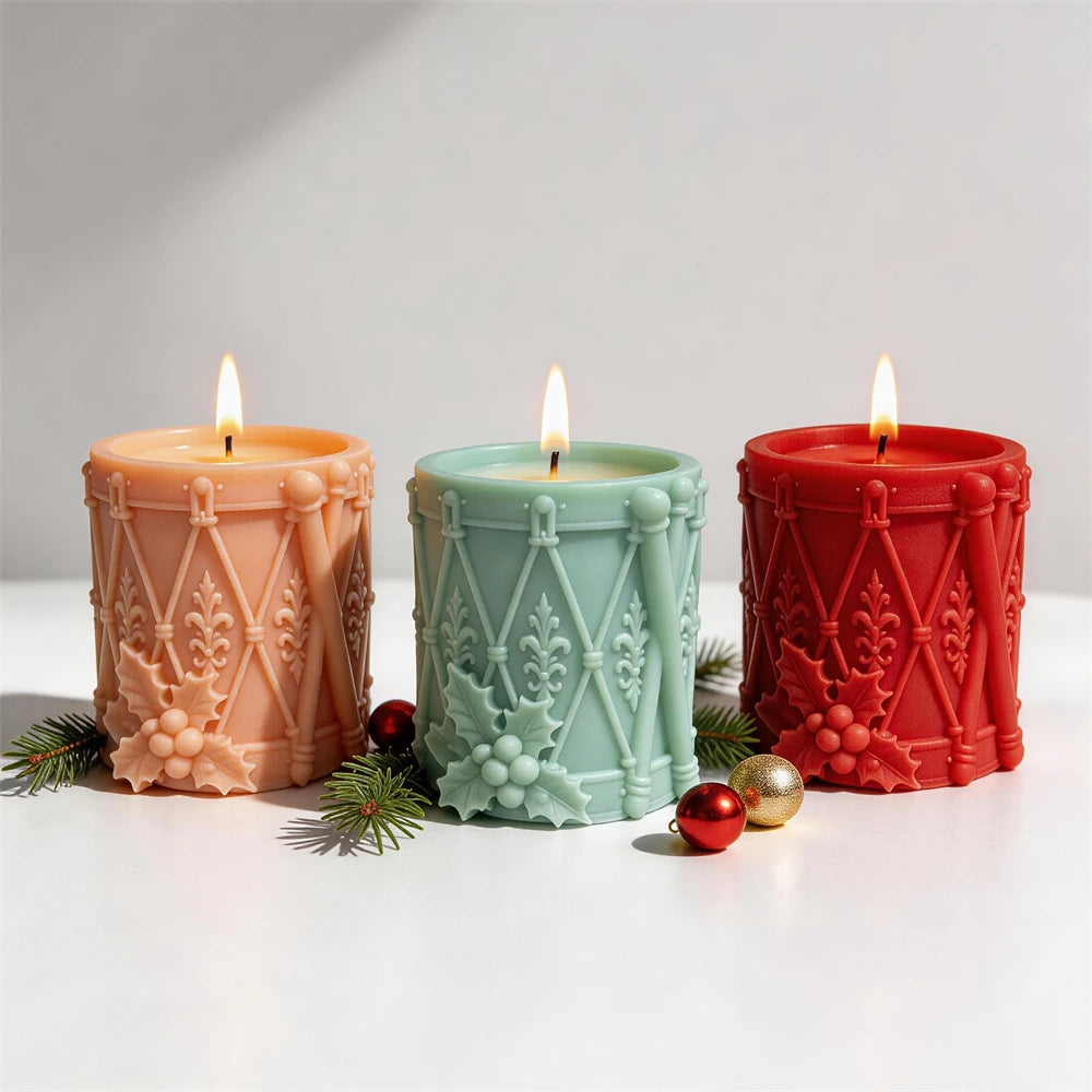 Christmas drum candles with holly leaves berries and decorative rope lacing