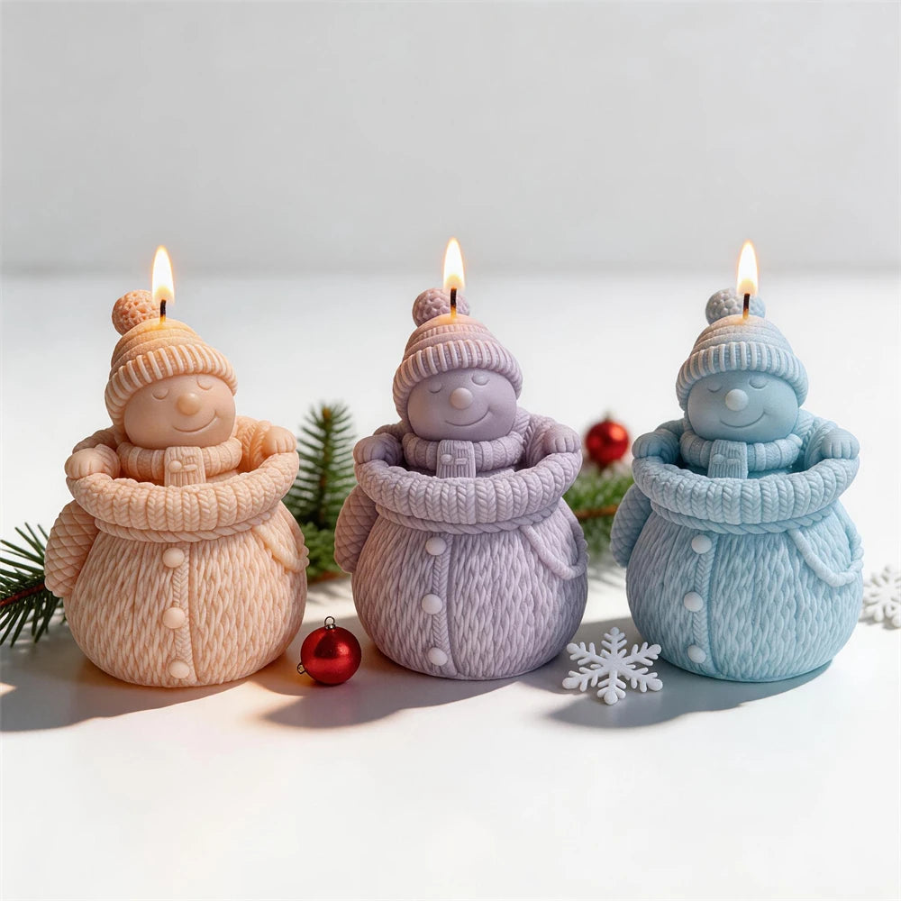 Knitted snowman candles with pom-pom hats and chunky winter scarves
