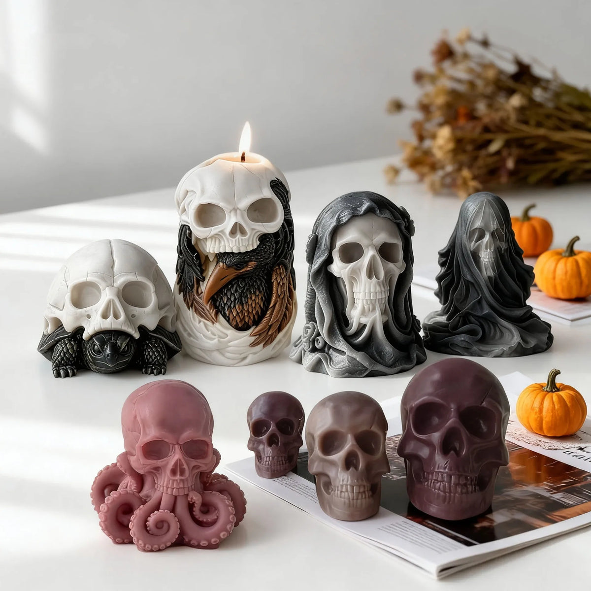 Gothic skull creature candles in octopus turtle raven and book designs