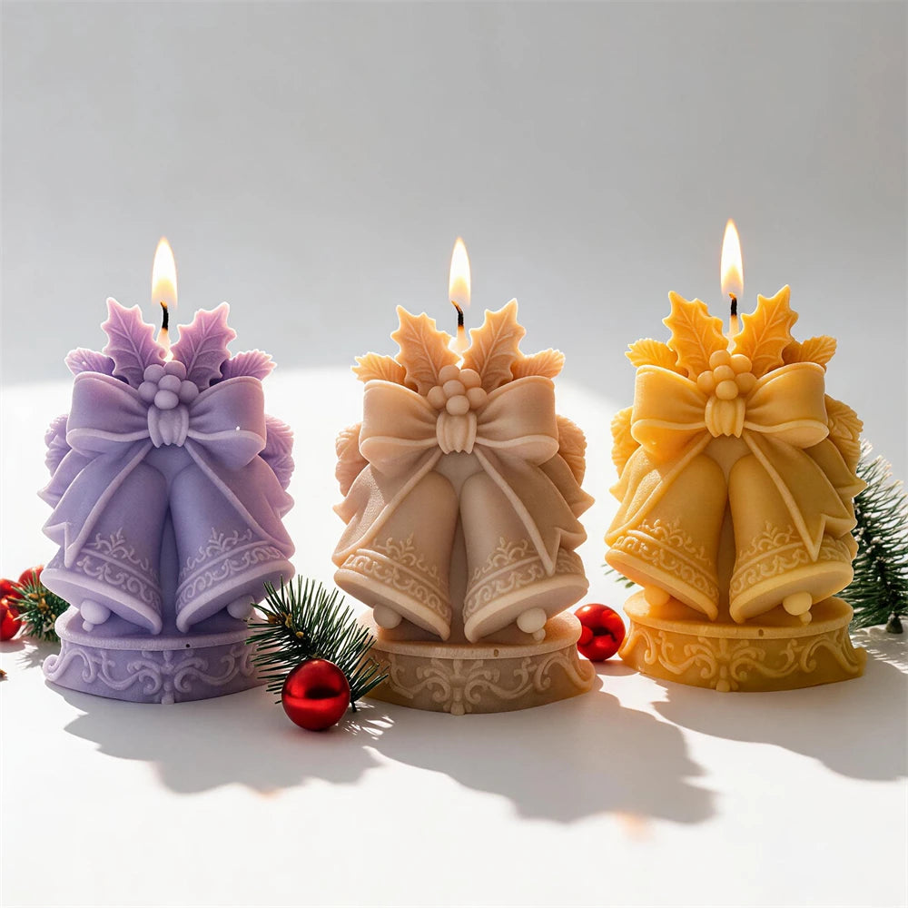 Festive twin bell candle with ribbon bow leaves and ornate patterned base